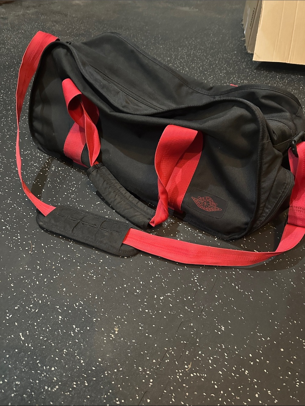 Nike Air Jordan Black Duffel Bag with Red Accents and Adjustable Strap